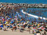 Multitude of swimmers and sunbathers at Playa Varese.