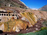 Ruined old spa and sulphuric sediment-covered rocks by the Rio de las Cuevas, Puente del Inca.