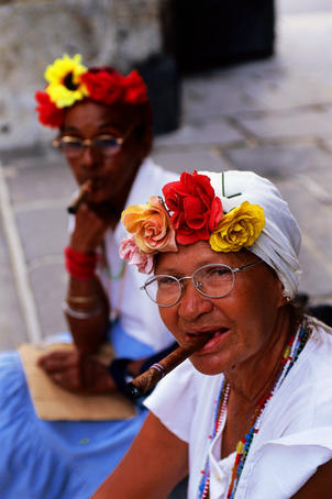 Portrait of cigar-smoking Cuban woman in Plaza de Armas.