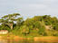 Idyllic riverfront scenery and rustic dwellings.