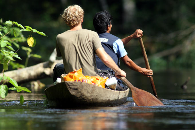 Tourist and guide paddling canoe on Rio Samiria.