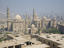 Sultan Hassan Mosque against the smoggy city background.