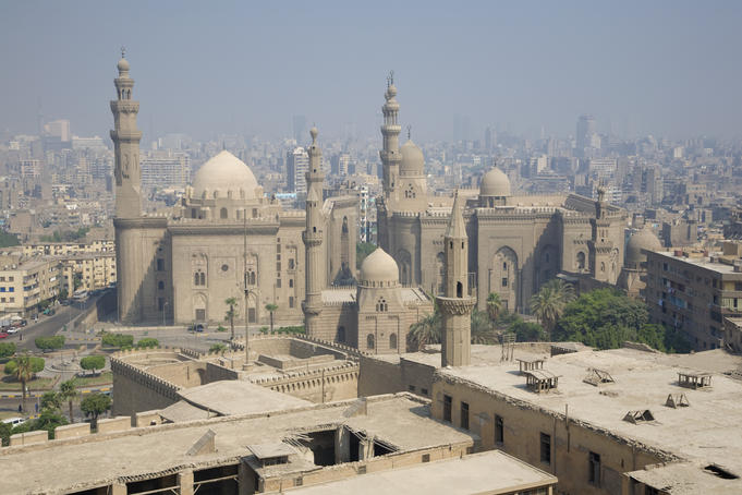 Sultan Hassan Mosque against the smoggy city background.