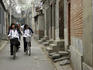 Cycling through a narrow Beijing hutong laneway.