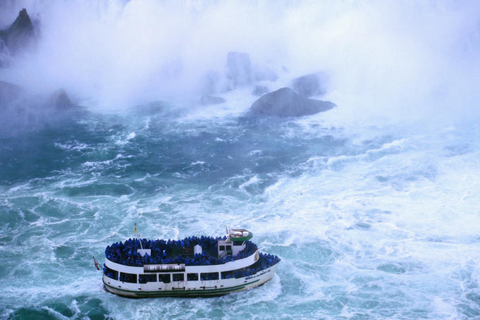 'Maid of the Mist' taking tourists for a wet ride in the spray of Horseshoe Falls, largest of the Niagara Falls.