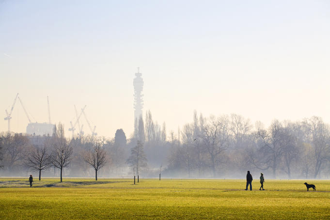 People in Regents Park on frosty morning with BT Tower in background.