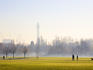 People in Regents Park on frosty morning with BT Tower in background.