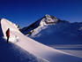 Climber and Mt French, with Mt Aspiring in background, at sunrise.