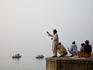 Men praying on the banks of the Ganges River at dawn.