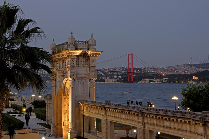 Palace Gate of the Ciragan Palace, with the Bosphorus Bridge spanning the Bosphorus Strait.