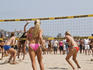 Women's beach volleyball team in action at the Manhattan Beach Surf Festival Volleyball Tournament.