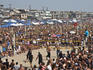 Volleyball games and crowds of spectators at the Manhattan Beach Surf Festival Volleyball Tournament.