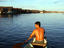 Man paddling on the Itaya River, with floating houses ahead, Belen neighbourhood.