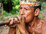 Yahua tribesman demonstrates shooting poison darts from a blowpipe at his village on the Nanay River.