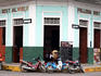 Motorbikes and scooters parked outside restaurant on Avenida Condamine, in the city centre.