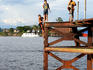 Young boy performing big swan dive at the Bella Vista Nanay Port.