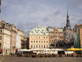 Outdoor cafes in Dome Square in old town Riga with the spire of St. Peter's Church in background.