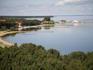 Nida's coastline and harbour on the Curonian Lagoon, as seen from the Parnidis Dune on a clear calm summer day.