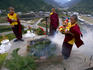 Young, future Buddhist monks making smoke offerings of juniper.