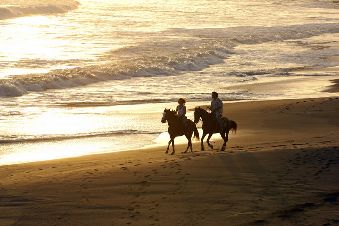 Couple horse-riding on Playa Los Destiladeros (beach).
