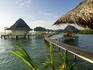 Wooden walkways leading out to cabins at Punta Caracol Hotel.