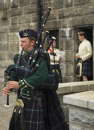 Costumed interpreters and a bagpipe player, Halifax Citadel National Historic Site.