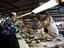 Customer buying fish at waterfront fish market.