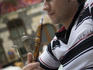 Man smoking sheesha water pipe, Jabri House courtyard restaurant.