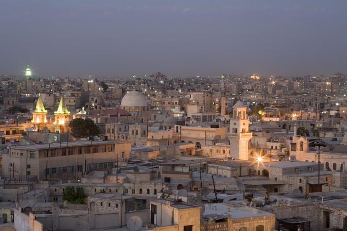 Overhead view of Aleppo city skyline at dusk from rooftop of Sheraton Aleppo Hotel.