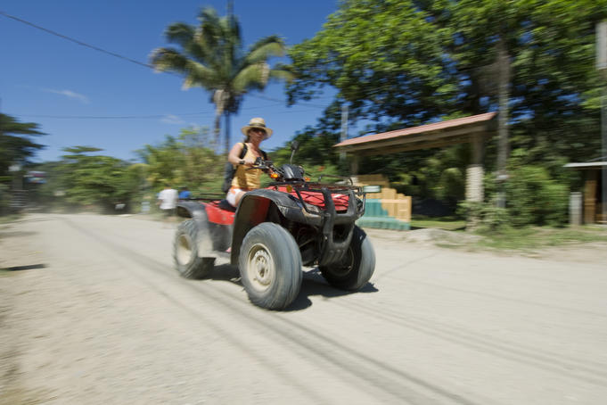 Woman travelling on a quad bike.