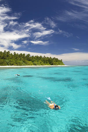 People snorkelling in the clear waters off an island in the Vava'u Group.