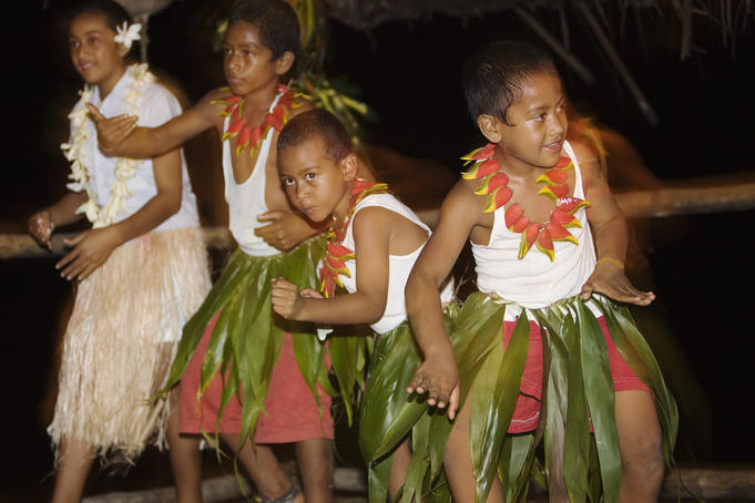 Children dancing at a Tongan feast on 'Ene'io Beach.