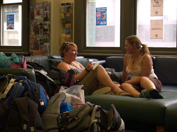 Backpackers relax in the lounge at Base ACB.