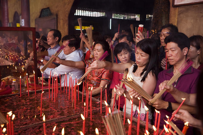 Devotees lighting incense at Lian Shan Shuang Lin Monastery also known as Siong Lim Temple.
