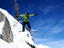 Snowboarder executes jump at Brighton ski resort in Wasatch Mountains