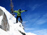 Snowboarder executes jump at Brighton ski resort in Wasatch Mountains