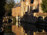 Canal with reflection of buildings and bridge.