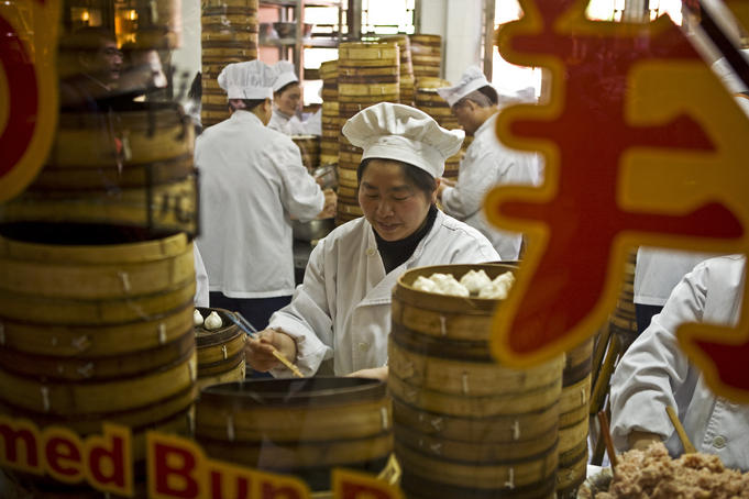 Staff making dumplings at restaurant in Yuyuan Bazaar in Old Town.