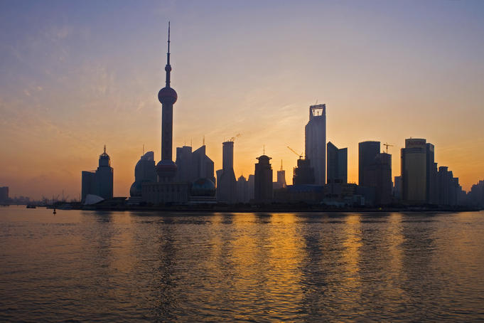 Pudong skyline & Huangpu River at sunrise from River Promonade on the Bund.