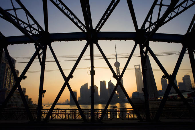 Pudong skyline & Huangpu River through Garden Bridge at sunrise.