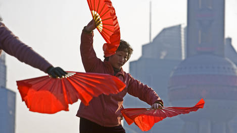 Women performing taichi on River Promonade on the Bund.
