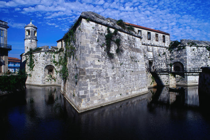 The stone walls of the Castillo Real de la Fuerza dip into a moat, in Colonial Havana
