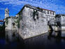 The stone walls of the Castillo Real de la Fuerza dip into a moat, in Colonial Havana