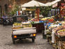 Fruit and vegetable stalls and small Piaggio truck at open market, Piazza di Trevi.