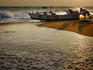 Fishermen pushing their boat out from Kollam Beach, heading out for the night shift.