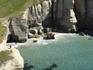 Aerial of tourists and cliffs at Tunnel Beach.