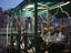 Grand Canal gondolieris await passengers near Rialto Bridge.
