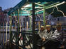 Grand Canal gondolieris await passengers near Rialto Bridge.