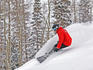 Snowboarder enjoying deep fresh powder at Brighton Ski Resort.