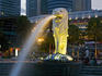 Merlion statue on waterfront at Merlion Park and city buildings.